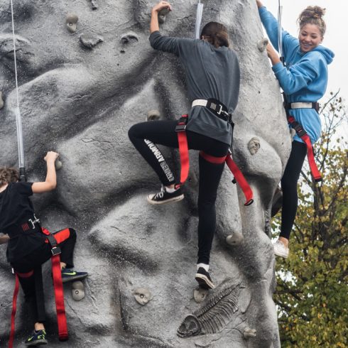 Three people on Rockclimbing wall Burtonsville Placemaking Festival